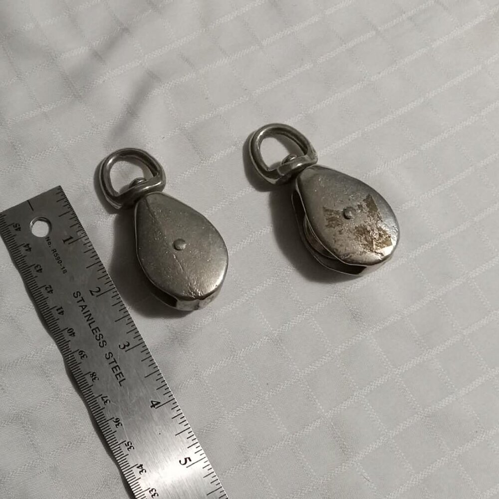 Two vintage metal pulleys, approx. 2 and 3/4 inches